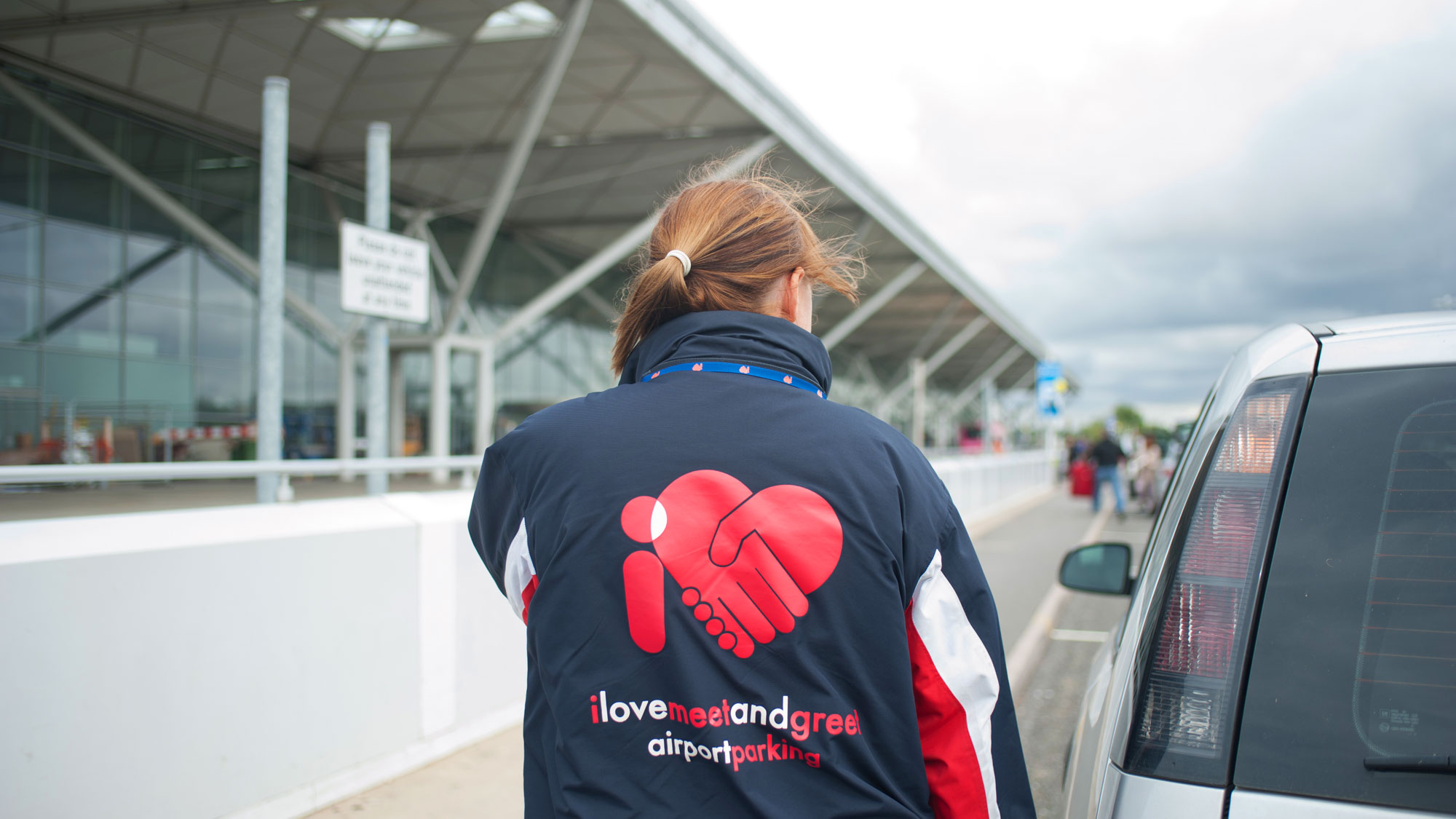 Woman waiting for car collection at Stansted